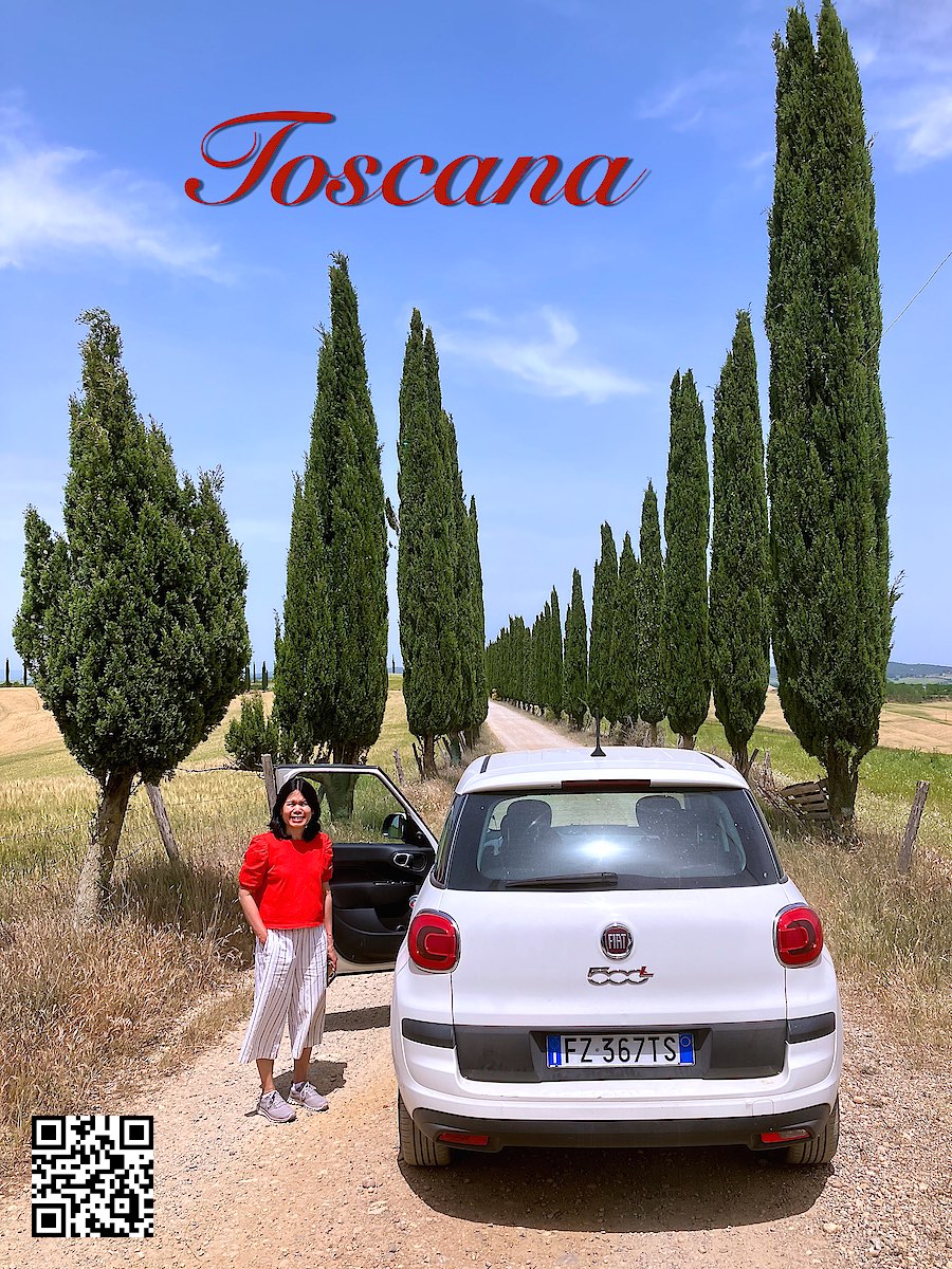 Italy Tuscany Toscana white Fiat 500L with woman in red shirt standing near the open door. Typical Tuscany landscape.