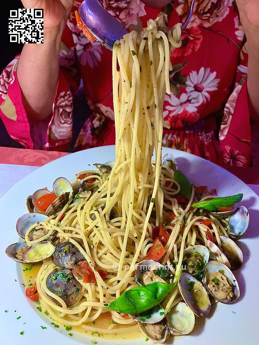 Italy Stresa Restaurant Torino spaghetti alle vongole woman pulling up