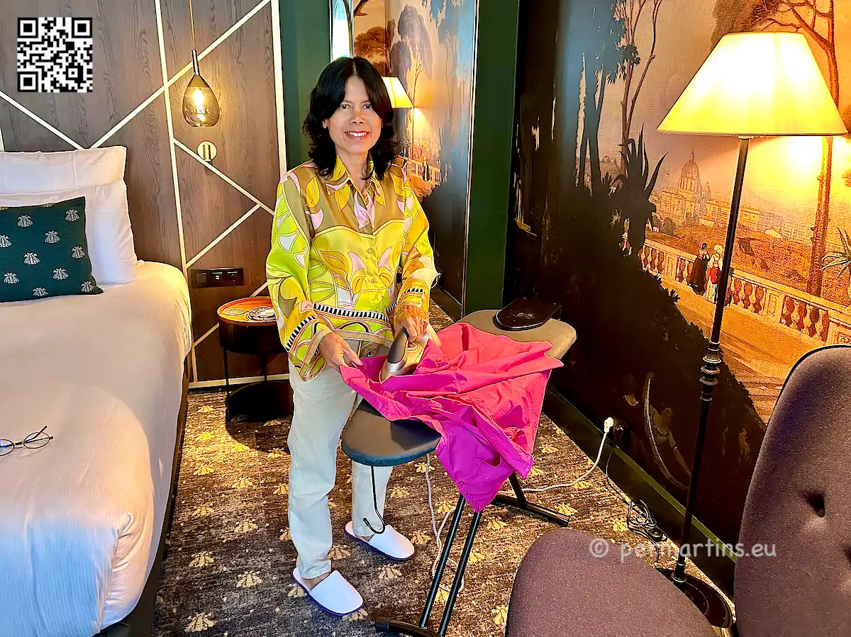 France Fontainebleau L´Aigle Noir Hotel MGallery, woman irons clothes in the room.