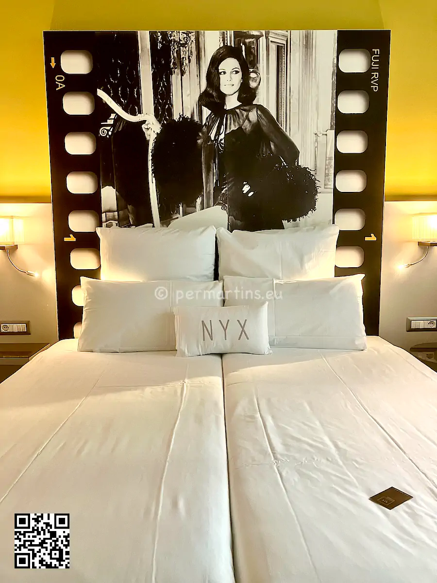 Italy Milano Hotel NYX, bed with a large black & white photo of a movie star behind.