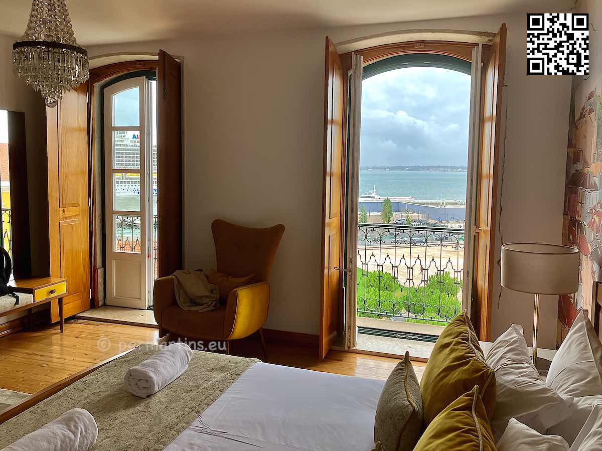 Portugal Lisbon, Varandas de Lisboa Tejo River Apartments, bed and two open balcony doors.