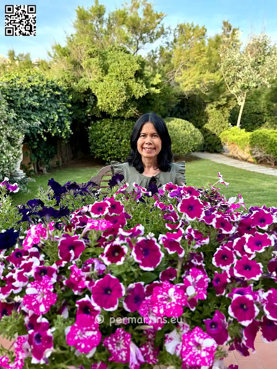 Italy Sardinia Alghero Villa Las Tronas woman flowers in the garden.