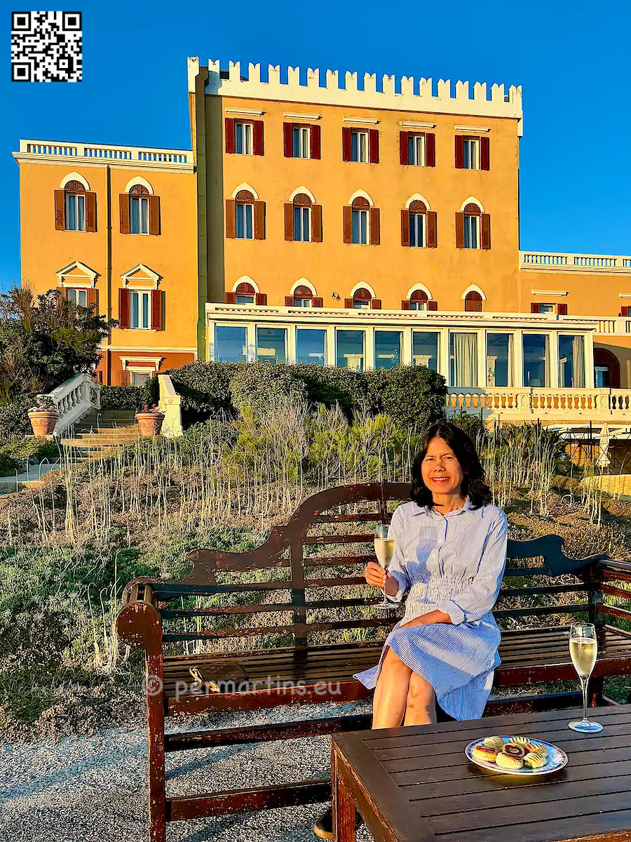 italy Sardinia Alghero Villa Las Tronas woman at sunset having a drink.