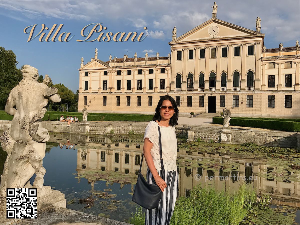 Italy Padova Parco Villa Pisani⁩ in Stra woman in front of a castle and a pond.