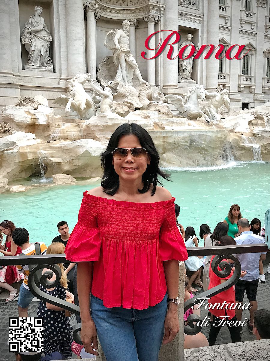 Italy Rome Roma woman in red in front of Fontana di Trevi.
