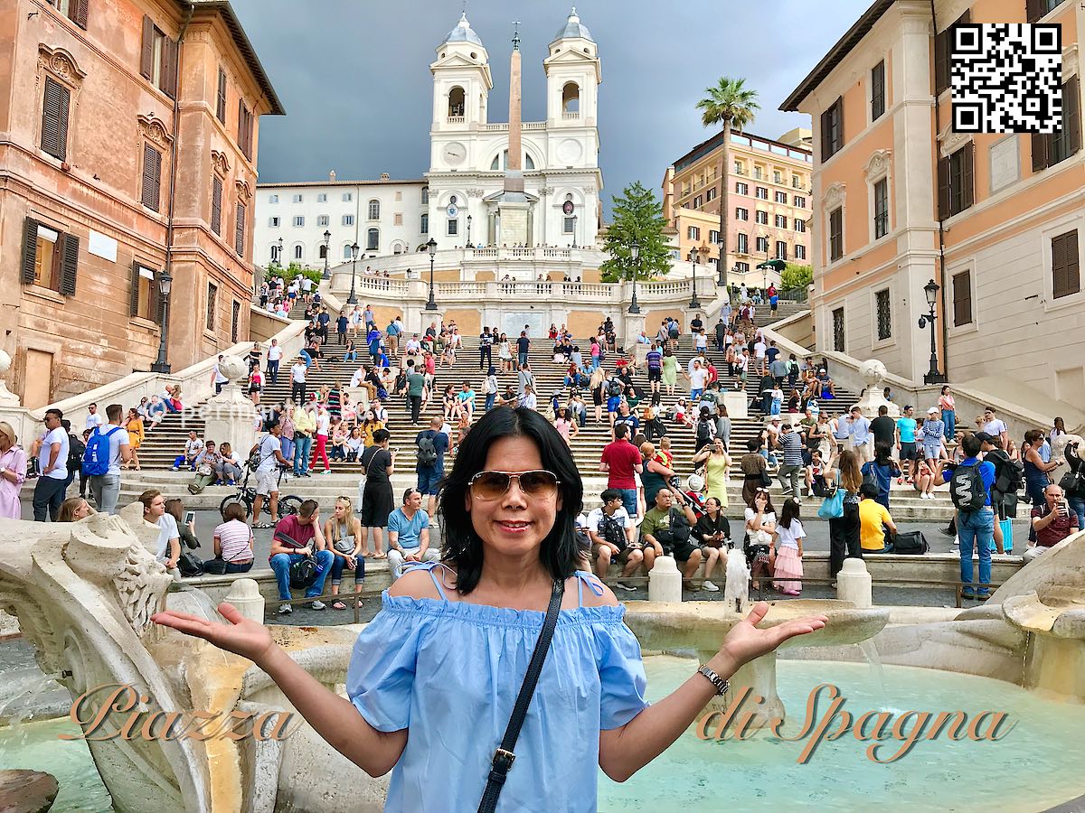 italy Rome Roma Piazza di Spagna woman in blue in front of a fontain and the Spanish Steps.