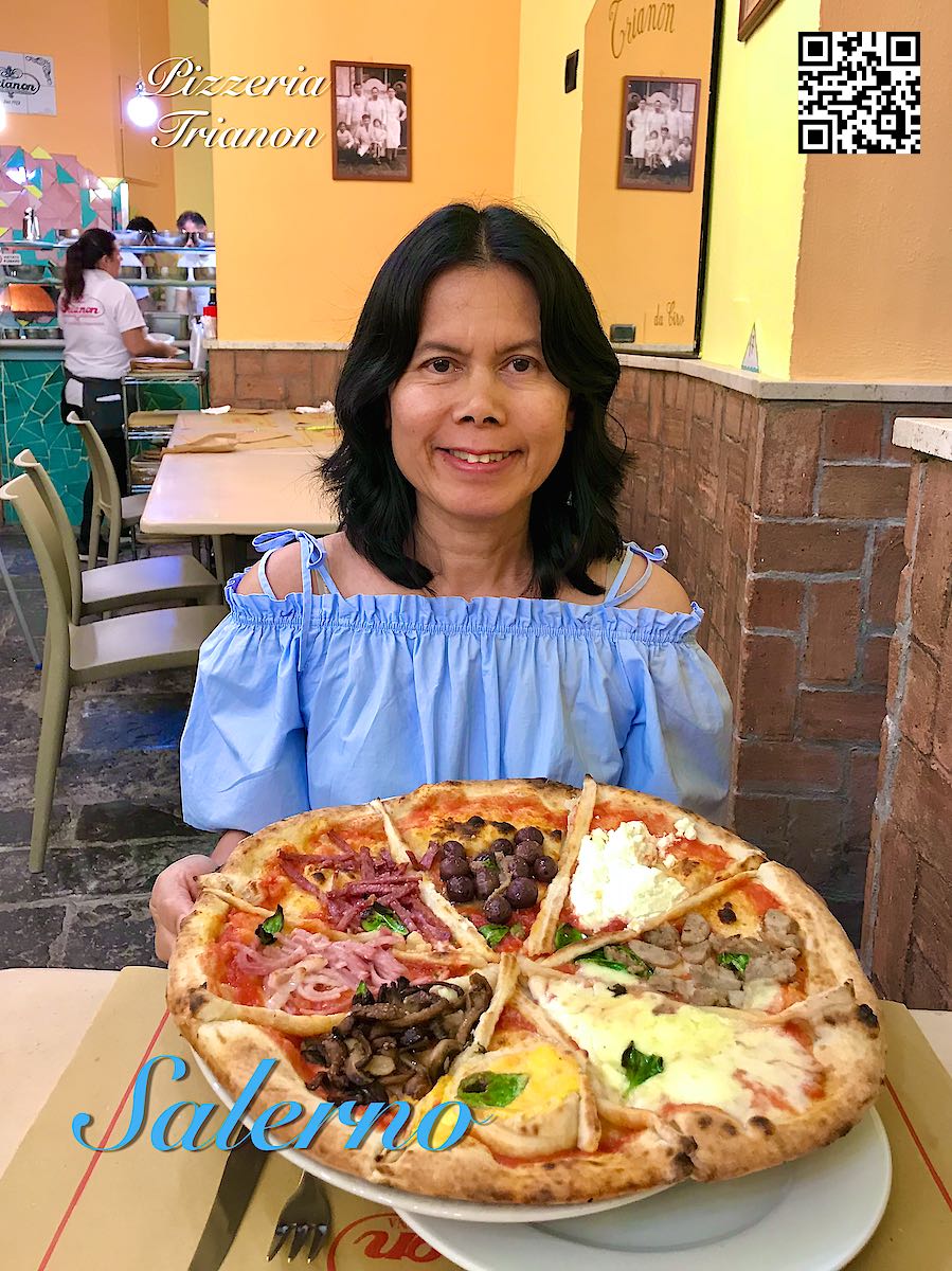 Italy Salerno woman holding a big pizza at Pizzeria Trianon.