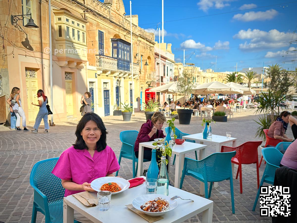 Malta Marsaxlokk woman eating pasta at Pastaus Lab restaurant.
