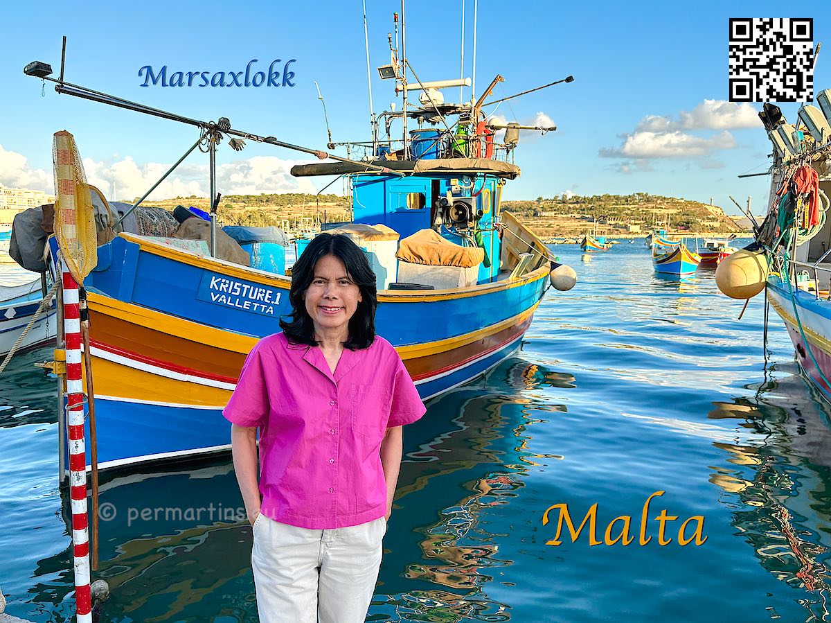 Malta Marsaxlokk fishing village picturesque harbour with colourful wooden boats and many seafood restaurants