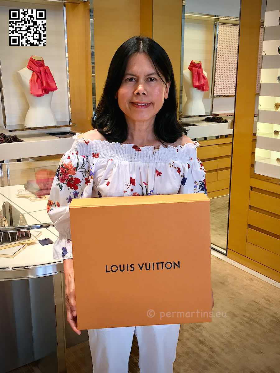 Italy Padova a woman holding an orange Louis Vuitton box.