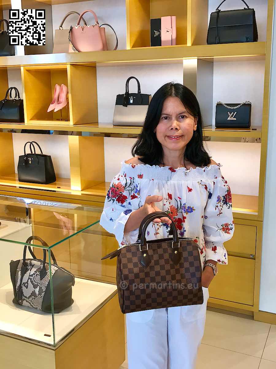Italy Padova woman holding a Louis Vuitton handbag.